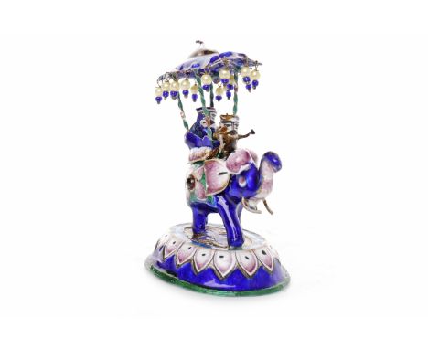 20TH CENTURY NORTH INDIAN ENAMEL ON SILVER MODEL OF AN ELEPHANTwith two riders under a canopy atop the elephant, 7cm high 