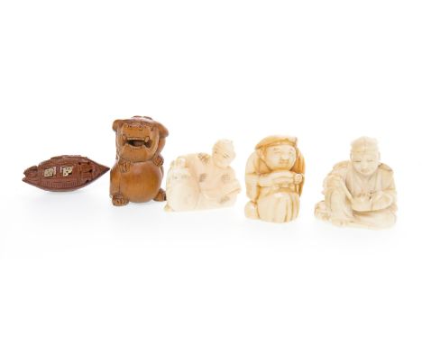 THREE EARLY 20TH CENTURY JAPANESE IVORY NETSUKESthe tallest, 3cm high; along with a wooden netsuke and a nut carving (5) 