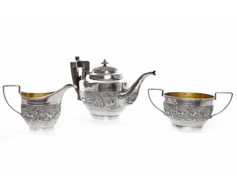 INDIAN SILVER TEA SERVICE comprising tea pot, sugar and cream, embossed with figures and animals in a hunting scene, the tea 