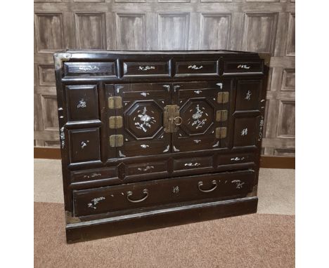 EARLY/MID 20TH CENTURY CHINESE CHEST with mother of pearl floral motifs to the front panels, two cupboard doors over a long d