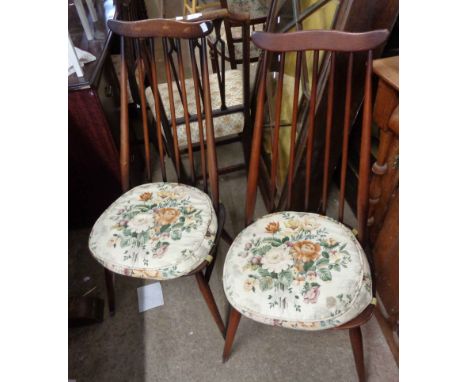 A pair of vintage Ercol dark stained wood high stick back dining chairs, set on simple turned supports
