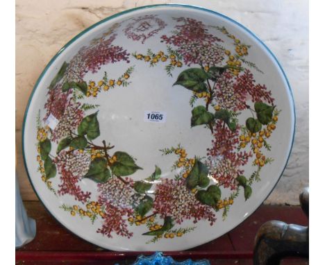 A 19th Century Wemyss Ware toilet bowl, decorated with hand painted floral garlands, a monogram and green banding to the rim 