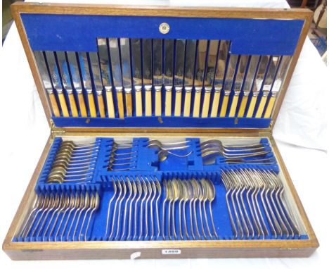 A vintage oak canteen containing an almost complete twelve place setting of Viners silver plated cutlery - ivorine handles va