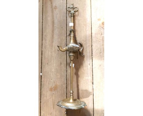 An old Eastern cast brass oil lamp of pillar form with handle to top