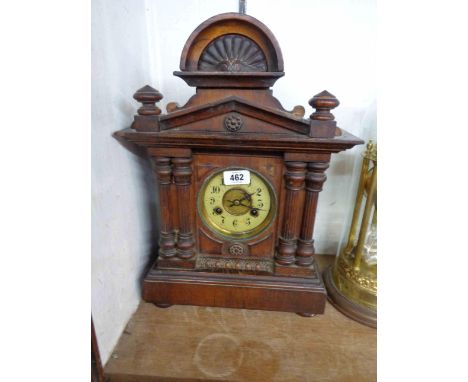 An early 20th Century stained walnut cased mantel clock with American gong striking movement