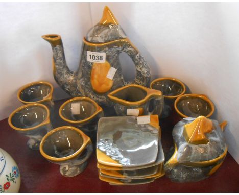 A vintage Vallauris Pottery coffee set comprising coffee pot, cream jug, sucrier and six cups and saucers, all of an angular 