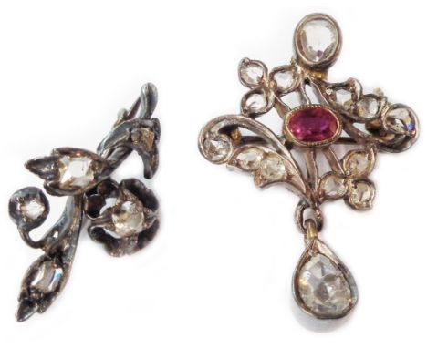An early 20th Century small bi-metal brooch, set with rose and old cut diamonds of varying shape and size with central oval r