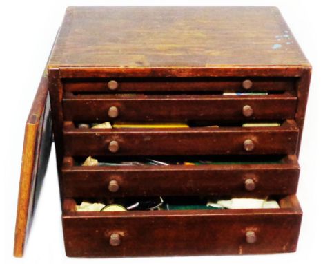 A vintage wooden engineer's chest of five drawers containing a large quantity of engineering tools