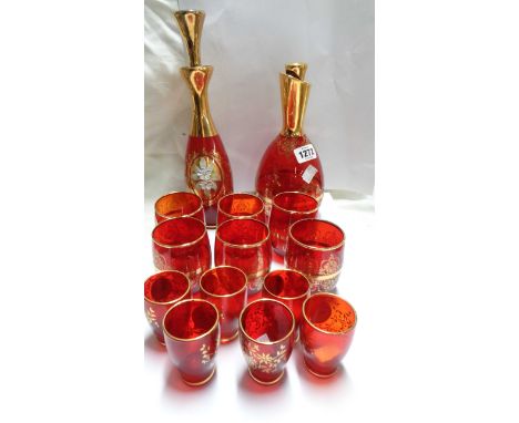 A Venetian ruby glass liqueur set comprising decanter and six glasses each decorated with hand painted floral decoration and 