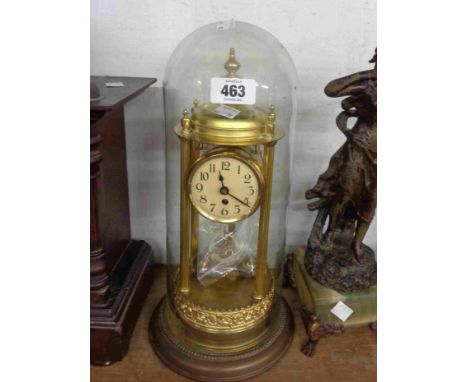 A vintage brass anniversary clock with adjustable double ball pendulum, under glass dome - suspension wire missing, dome glue