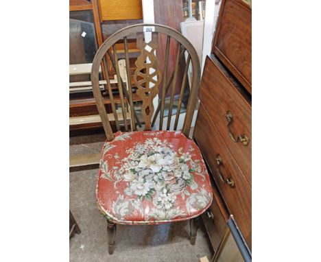 A pair of vintage stained oak wheelback standard chairs, set on turned supports