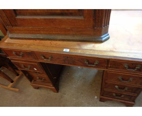 A 1.2m vintage mahogany twin pedestal desk with red leather inset top, three frieze drawers and five flanking pedestal drawer