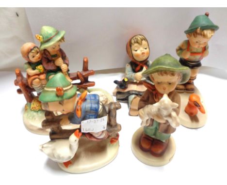 Five Hummel figures including seated knitting girl, boy with rabbit, etc.