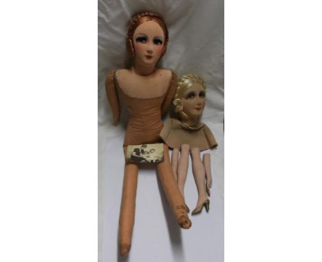A vintage felt bodied doll with painted face detailing - sold with a similar doll's head bust with separate ceramic legs and 