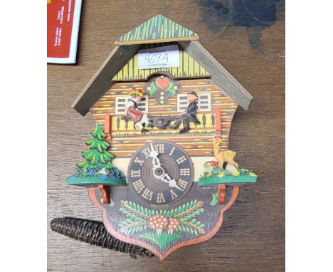 A tourist ware painted wood cuckoo clock with simple German movement