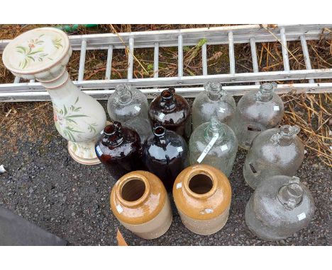 Nine vintage glass demijohns - sold with two stoneware flagons and a ceramic plant stand