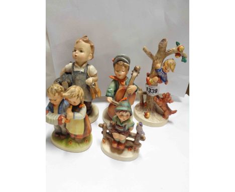 Five Hummel figures including boy with cello, Shoemaker boy, etc.