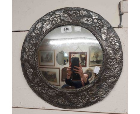 A 37cm diameter vintage embossed pewter clad framed convex wall mirror