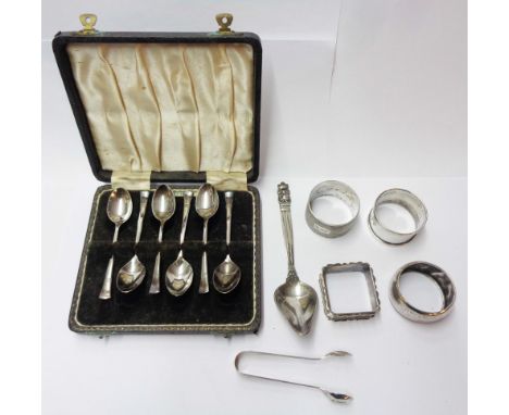 A cased set of six silver coffee spoons - sold with four silver assorted napkin rings - all personalised, a pair of sugar ton