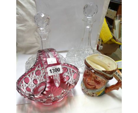 A cased and flash cut ruby glass basket - sold with two cut glass ship's style decanters and a pottery character jug