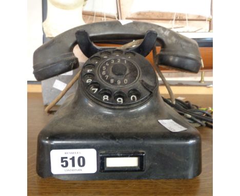 A vintage black Bakelite dial telephone