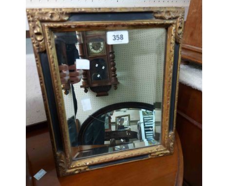 A vintage part ebonised and gilt framed dressing table mirror with bevelled oblong plate and polished wood easel back