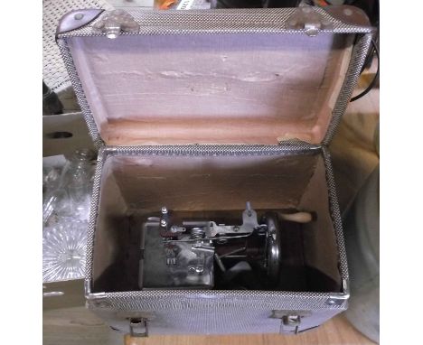 A cased vintage child's sewing machine