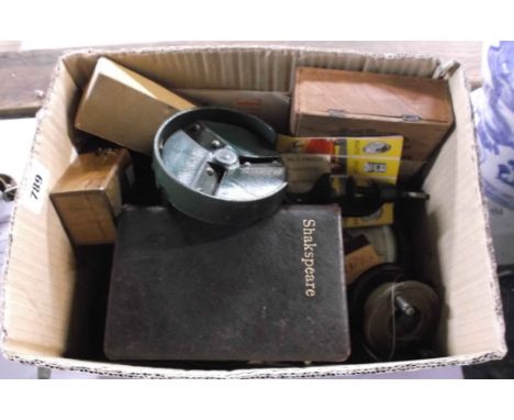 A box containing a quantity of collectable items including vintage yard measures, wax seal sticks, barometers, hand crack bea