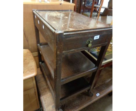 A 59cm vintage oak two tier tea trolley with single drawer, set on casters