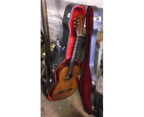 A Jose Alvarez Spanish guitar in a hard carry case - sold with a vintage green canvas covered suitcase