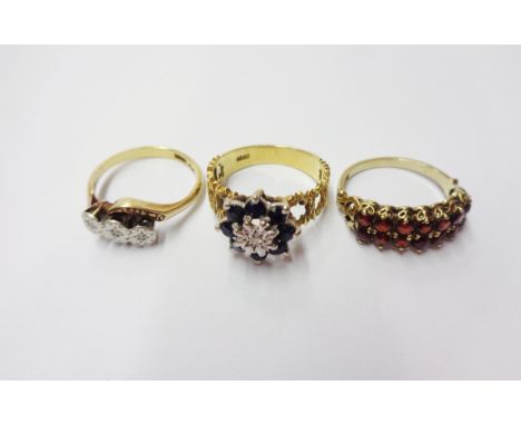 A marked 18ct. vintage yellow metal ring, set with tiny central diamond within a dark sapphire border - sold with a marked 18