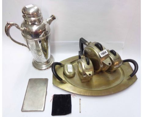 An Art Deco silver plated three piece tea set of circular form and tea tray, a silver cigarette case with engine turned decor