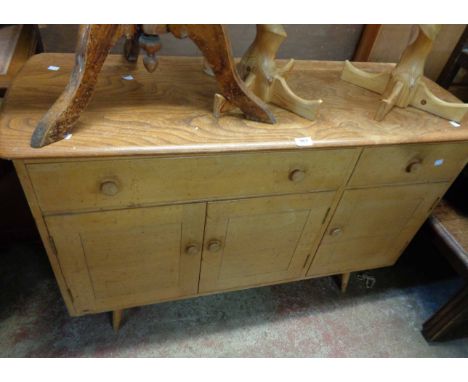 A 1.2m vintage Ercol sideboard with natural elm moulded top and applied cream coloured finish, with two drawers and triple cu