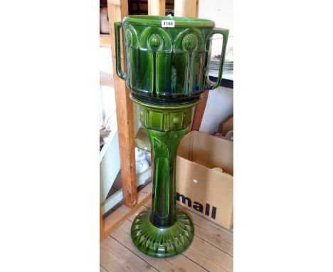 A large Bretby pottery Art Nouveau jardinière and stand with moulded Secessionist decoration and a green lustre glaze finish 