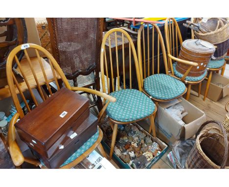 A set of six Ercol light elm hoop stick back dining chairs, set on tapered supports - comprising four standard and two carver