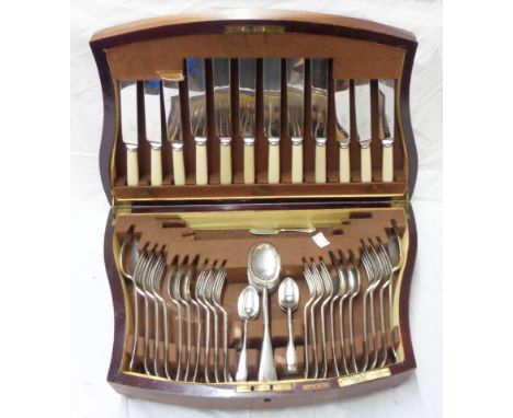 A vintage mahogany canteen containing a part six place setting of Joseph Rogers &amp; Sons silver plated cutlery, the knives 