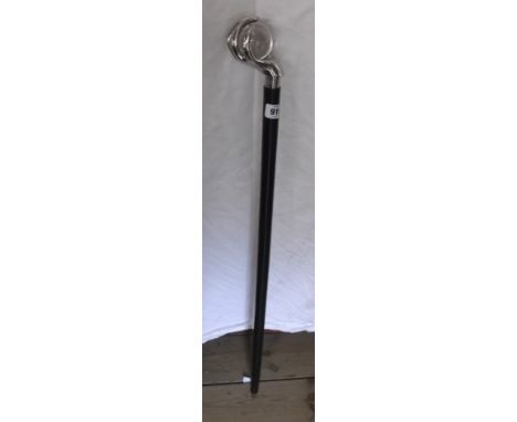 A modern walking stick with polished metal and glass claw and ball handle