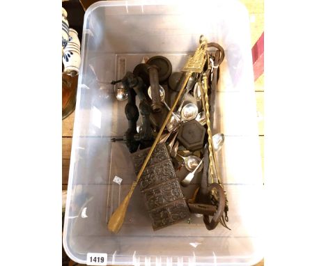A crate containing a quantity of metalware including cast iron door knocker, brass toasting forks, etc.