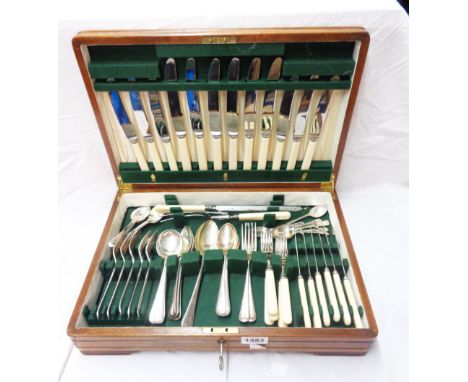 A vintage walnut veneered canteen containing a part set of ivorine handled silver plated cutlery
