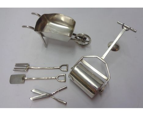 A silver miniature lawn roller, wheelbarrow and three gardening tools with stand - by Edward Victor Stanley, London 1996/97