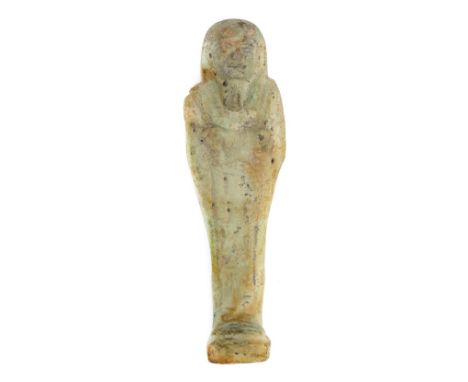 *Ancient Egypt. 26th Dynasty, pale green faience Shabti of Pewi-Wia,  the mummiform figure modelled tripartite wig and long b