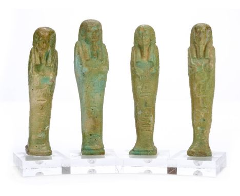 *Ancient Egypt. 26th Dynasty, green faience Shabti of Ankh-her,  the mummiform figure modelled wearing tripartite wig, long b