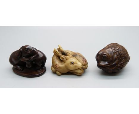 Three carved netsuke, elephants, deer and fish 