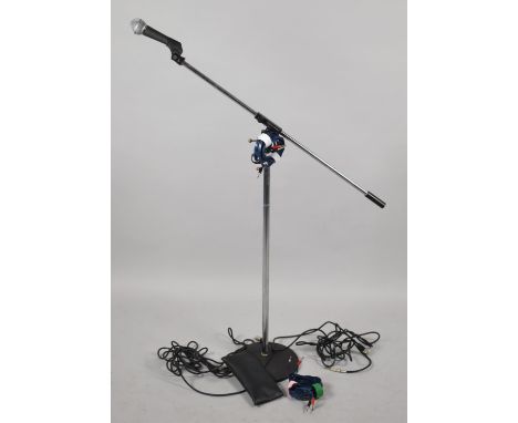 A Sure SM58 Microphone Together with a Realistic Microphone Stand and Speaker Cables 