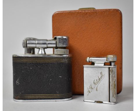 A Vintage Roller Beacon Lighter Engraved A R Mitchell together with a Desk Top Cyclops Lighter by Merlin Products and a Leath