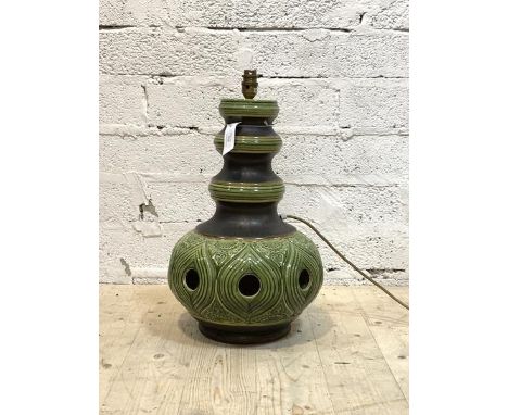 A large ceramic table light, circa 1970, of pierced baluster form with green and brown glaze, stamped W. German under, H49cm