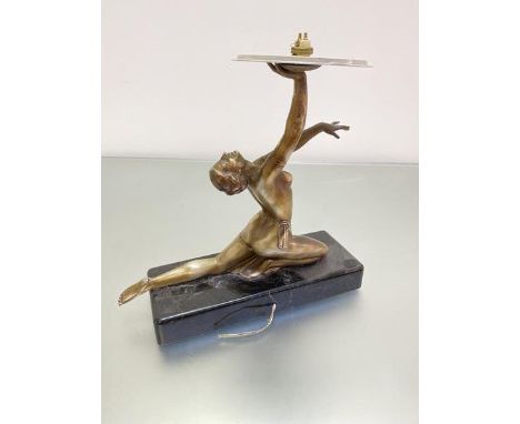 An Art Deco bronzed metal Dancing 1920s figure, with arm upraised, mounted on rectangular black marble base, designed as lamp