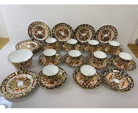 An early 20thc Royal Crown Derby Imari pattern teaset including ten cups, one with repairs (6cm), twelve saucers, ten side pl