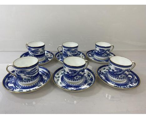 A set of six early 20thc Royal Crown Derby demi tasse cups and saucers in chinoiserie blue and white pattern depicing dragons