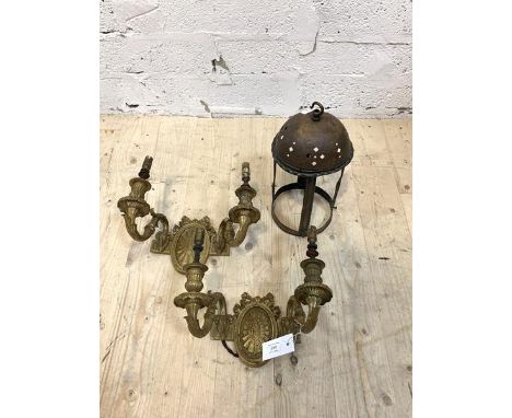A pair of gilt brass twin branch wall sconces of Neoclassical design, the back plate with ribbon swags over paterea, flanked 